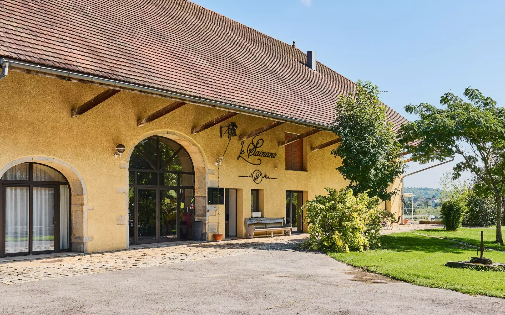 Façade de la ferme rénovée avec terres agricoles BIO à vendre proche de Montbéliard – Arrière-Cour, agence immobilière spécialisée à Montbéliard