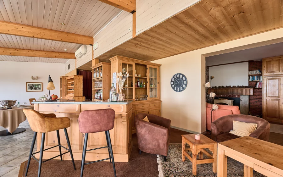 Pièce de réception de l'hôtel ouvert sur les forêts du Jura à vendre - Arrière-Cour, agence immobilière spécialisée dans le Jura