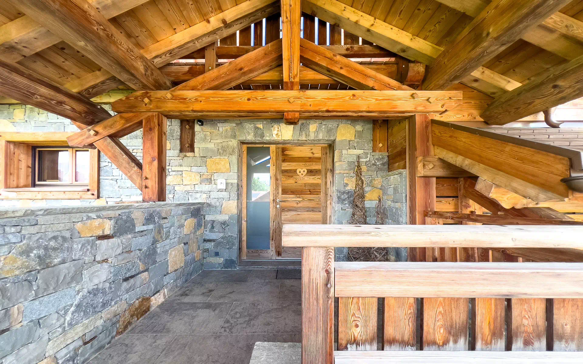 Intérieur d’un chalet ancien avec charpente en bois apparente